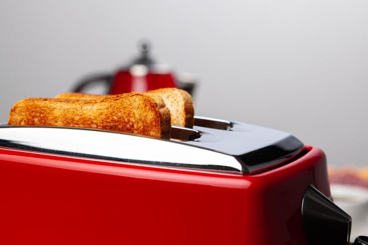 Close up image of red toaster, with cooked toast