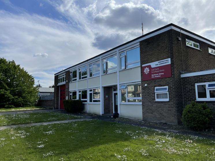 Brick fire station building with grass at the front