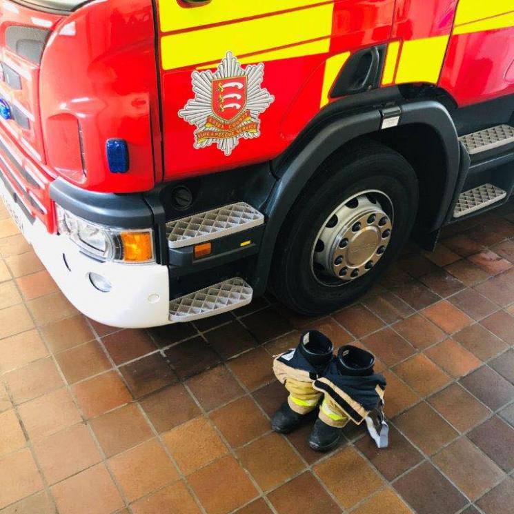 Fire engine with fire boots and tunic on the floor