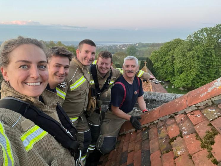 Five members of Manningtree's crew on top of the church roof