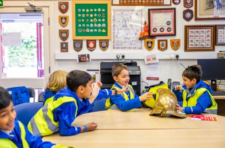 school children sitting at the fire museum