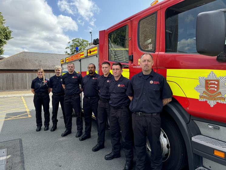 Seven new on-call firefighters in front of a fire engine
