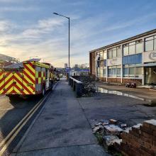 Fire engine parked outside a derelict building