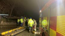 Firefighters and coastguard rescuing a man from the mud