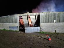 An outbuilding on fire