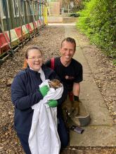 Firefighter Jon Foot and a colleague in the RSPCA holding the fox