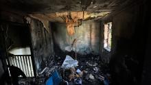 A fire and smoke damaged bedroom after a candle fire