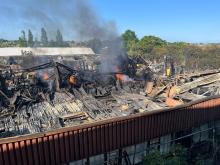 Flames coming out of a large workshop