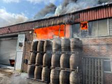 Flames coming out of a large workshop