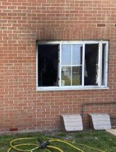 Smoke damaged windows on a ground floor flat