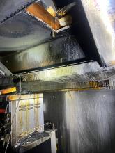 A burnt extractor fan after a grease fire