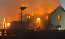 A house and outbuilding on fire