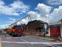 fire engine and tall ladder pouring water on a building fire