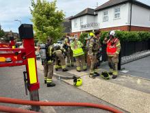 Firefighters putting on Breathing Apparatus to enter the house 