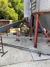 Firefighters working to extinguish a fire in two grain silos