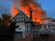 A derelict building on fire
