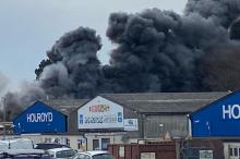 Black smoke above an industrial estate