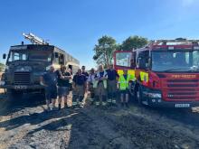 Colin alongisde firefighters at a field fire last summer with his Green Goddess fire engine and one of our fire engines