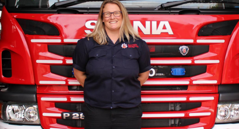 Station Manager Karen Nicoll standing in front of a fire engine