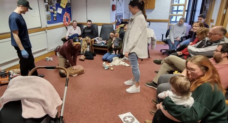 Firefighters giving first aid training inside fire station