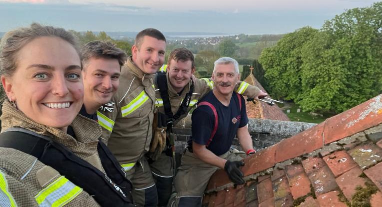 Five members of Manningtree's crew on top of the church roof