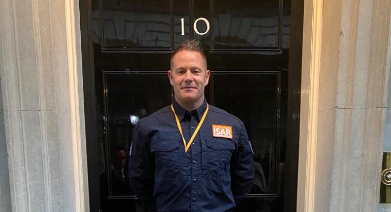 Scott Meekings stands outside No. 10 Downing Street's famous black door