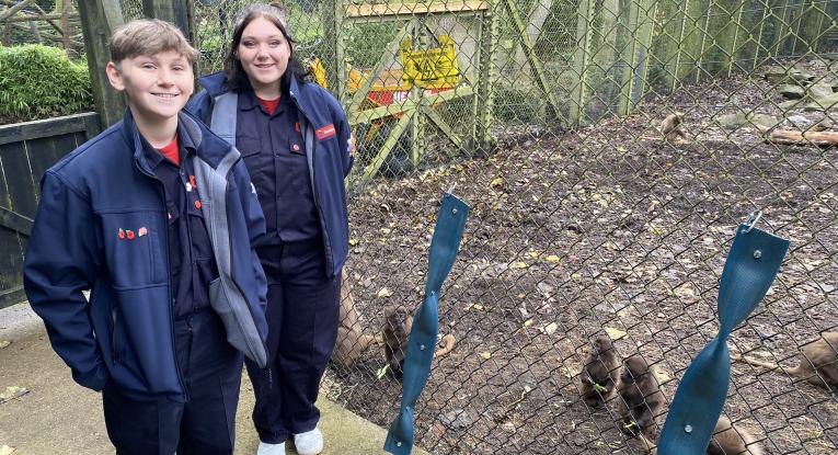 Zak and Jorge with puzzle feeders made from old fire hoses for Gelada Baboons at Colchester Zoo