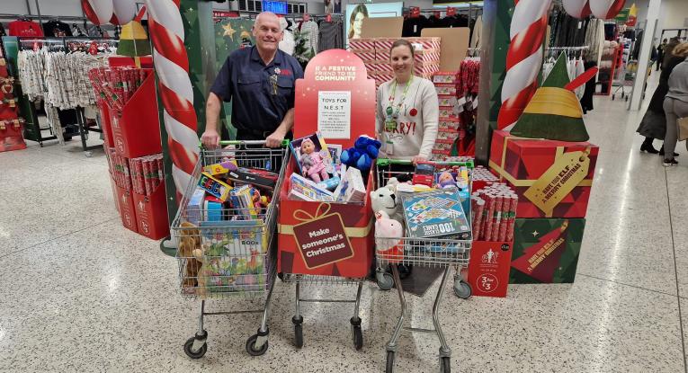 Les Nicoll with volunteer shopping for Christmas hamper donations