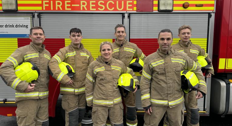Six new on-call firefighters stand infront of fire engine