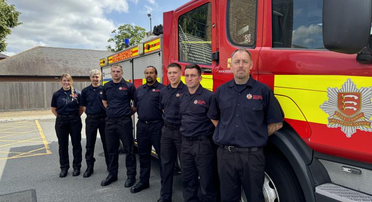 Seven new on-call firefighters in front of a fire engine