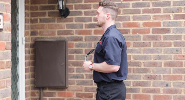 A home safety officer standing outside someone's house