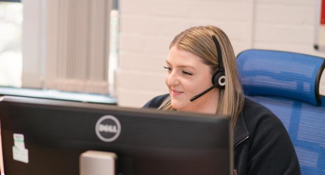 A call centre worker in front of a computer screen